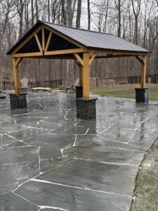 Lagoon like pool patio using natural irregular slabs of bluestone. We constructed the pergola and sat it upon pillars of stacked snap bluestone.