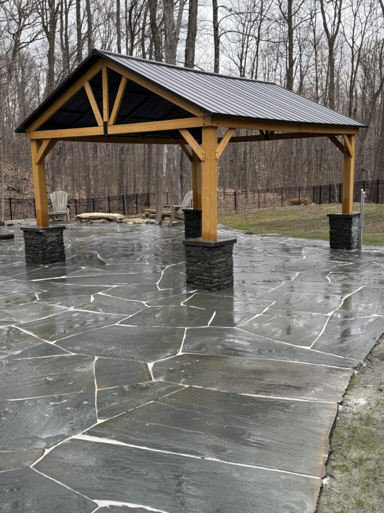 Lagoon like pool patio using natural irregular slabs of bluestone. We constructed the pergola and sat it upon pillars of stacked snap bluestone.