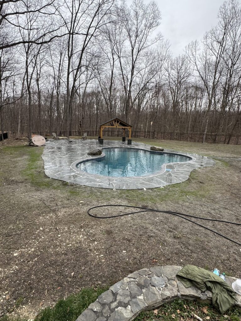 Lagoon like pool patio using natural irregular slabs of bluestone. We constructed the pergola and sat it upon pillars of stacked snap bluestone.