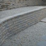 Manufactured stone tiered walls