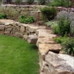 Natural stone rustic tiered retaining wall