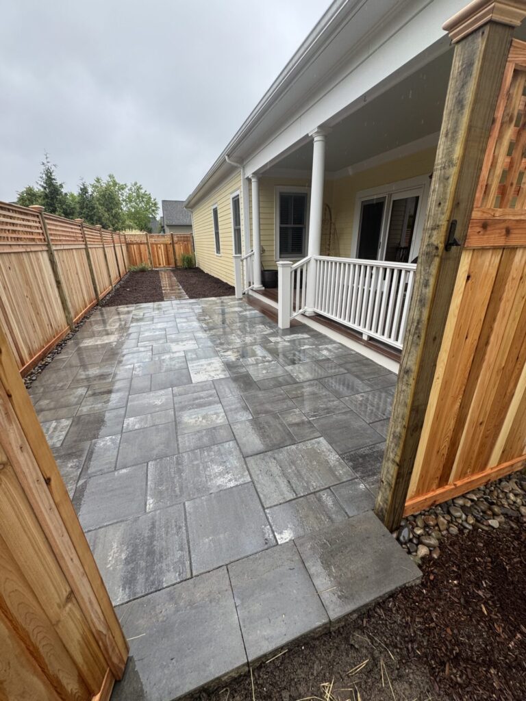 The Cambridge Sherwood Ledgestone 3-piece kit in XL smooth, shown in Limestone Quarry Blue, matched with the Interstate Oklahoma privacy fence with cedar double-sided panels and a square lattice topper.