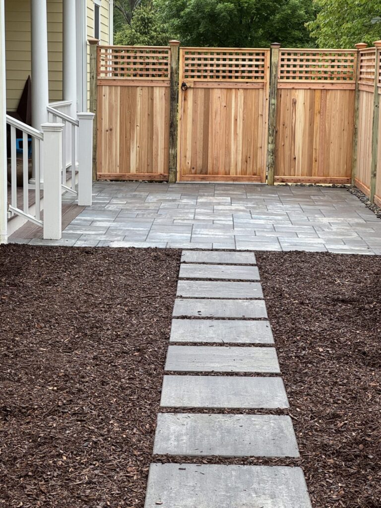 The Cambridge Sherwood Ledgestone 3-piece kit in XL smooth, shown in Limestone Quarry Blue, matched with the Interstate Oklahoma privacy fence with cedar double-sided panels and a square lattice topper.