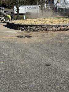 Front yard retaining wall with fieldstones and Cambridge Split Faced Onyx Natural Caps.