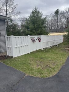 White vinyl board-on-board fence.