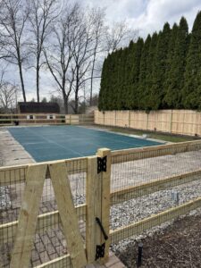 three-rail wooden fence with black welded wire and cedar privacy picket fence.