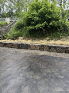 Rebuilt driveway retaining wall using natural stones.