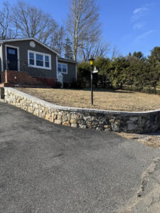 Rebuilt stone retaining wall and added a Cambridge Natural Onyx cap