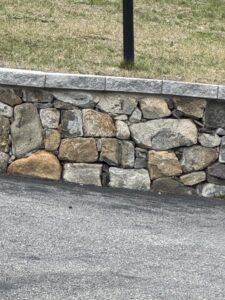 Rebuilt stone retaining wall and added a Cambridge Natural Onyx cap