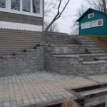 Manufactured stone tiered walls and steps