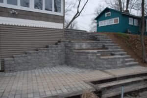 Manufactured stone tiered walls and steps