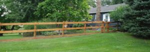 Wood split-rail fence with wire mesh