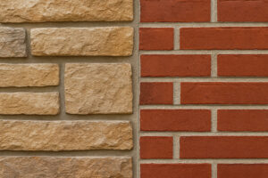 Close-up of beige stone veneer alongside traditional red brick siding, showing a well-matched combination of textures and colors for exterior home design.