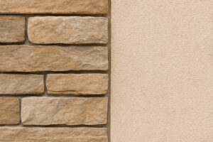 Close-up of beige stone veneer next to off-white stucco wall, showing a complementary match of natural textures and warm undertones for exterior home design.