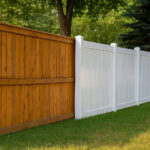 Side-by-side comparison of a natural wood fence and a white vinyl fence in a residential yard, showing the visual and material differences between the two options.